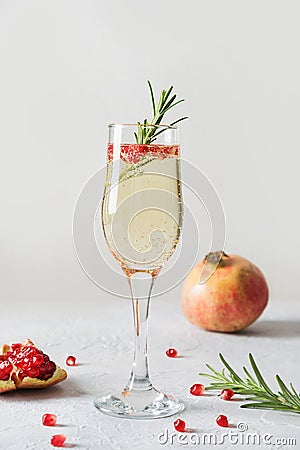 Pomegranate Christmas cocktail with rosemary, sparkling wine on white. Xmas Holiday drink Stock Photo