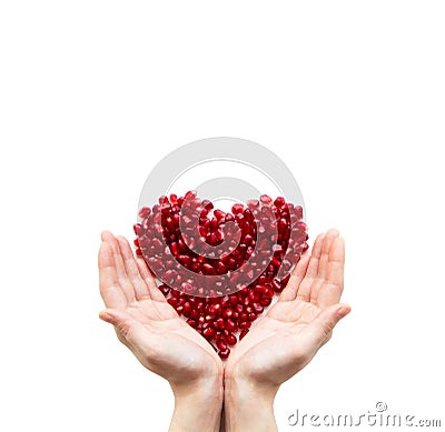 Pomegranate heart in hands Stock Photo