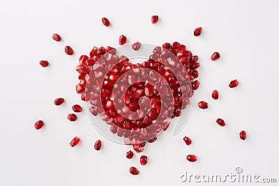Pomegranate seeds in a shape of a heart Stock Photo