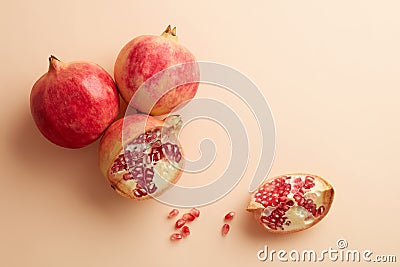 Pomegranates on a grey tray on pastel pink background Stock Photo