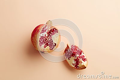 Pomegranates on a grey tray on pastel pink background Stock Photo