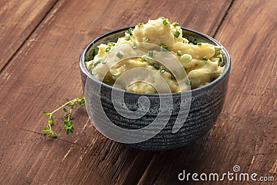 Pomme puree, a photo of a bowl of mashed potatoes with herbs Stock Photo