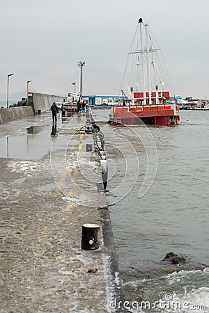 Sunken pleasure boat at the pier in Bulgarian Pomorie Editorial Stock Photo
