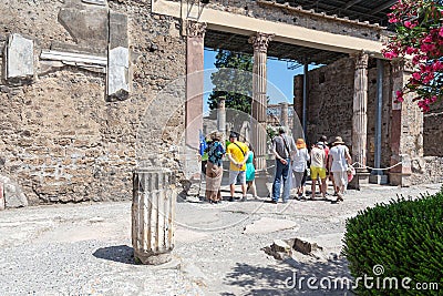 Pompeii, Company, Italy - June 25, 2019: A group of tourists inspects the ruins of the ancient city Editorial Stock Photo