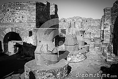 POMPEII, ITALY - MAY 04, 2022 - Millstones of a bakery in the ancient city of Pompeii Stock Photo