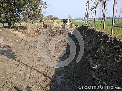 Pond create by jcb in village for fish cradle Editorial Stock Photo