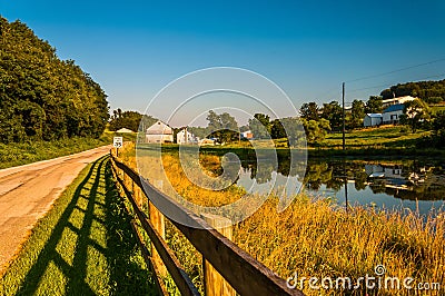 Pond and fence along a country road in York County, Pennsylvania Stock Photo