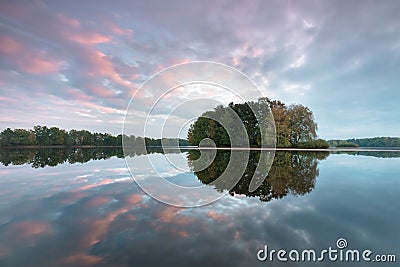 Pond with a tiny round island. Calm Water Of Lake, River, Forest On Other Side. Landscape. Mountain valley lake Stock Photo