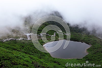 Pond and Walking Path in Mountain Stock Photo