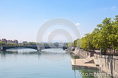 Pont de l`Universite bridge in Lyon, France over a panorama of the riverbank of the Rhone river Quais de Rhone Stock Photo