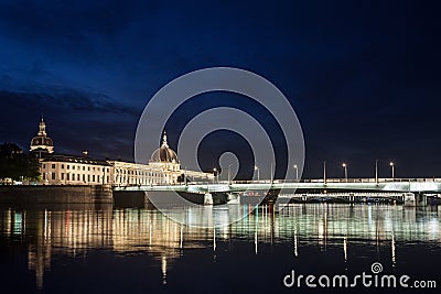 Pont de la Guillotiere bridge in Lyon, France over a panorama of the riverbank of the Rhone river Quais de Rhone at night Stock Photo