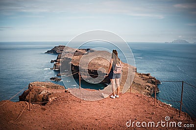 Ponta De Sao Lourenco at Madeira Islands - Portugal, Beautiful woman standing against view. View of rocks, beach, cliffs and mount Stock Photo