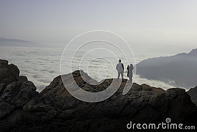 Young lovers on a boulder admiring the mountains Editorial Stock Photo