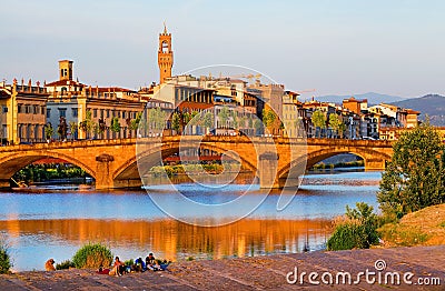 The Ponte Santa Trinita over Arno river at sunset, seen from the attractive promenade Lungarno Guicciardini in Florence. . Stock Photo