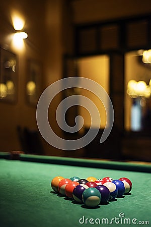 Pool balls on billiards table in cozy bar Stock Photo