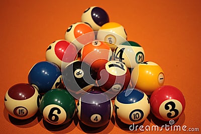 Pool balls pyramid on orange cloth for eightball game Stock Photo