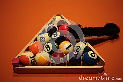 Pool balls pyramid on orange cloth for eightball game Stock Photo