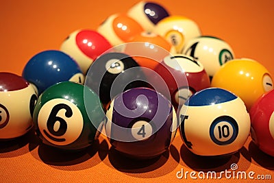 Pool balls pyramid on orange cloth for eightball game Stock Photo