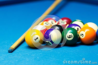 Pool billiard balls and cue on the table Stock Photo