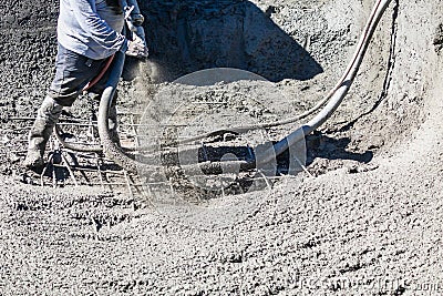 Pool Construction Worker Shooting Concrete, Shotcrete or Gunite Through Hose Stock Photo