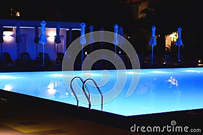 Pool illuminated at night Stock Photo