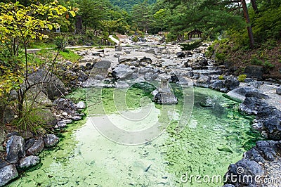 Pool with mineral hot spring water in Kusatsu park in Japan Stock Photo