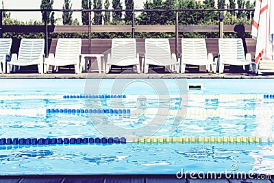 Pool with swimming paths and sun loungers and parasols Stock Photo