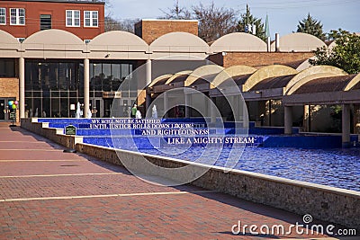A pool water with blue tile around the crypts of Martin Luther King and Coretta Scott King surrounded by a pool of rippling Editorial Stock Photo