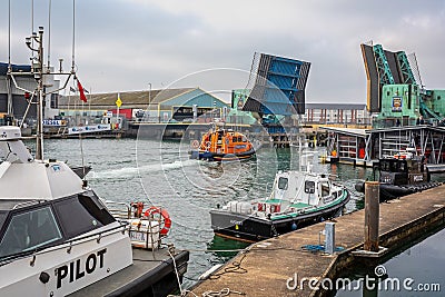 Poole lifting bridge in raised position as RNLI lifeboat passes through in Poole, Dorset, UK Editorial Stock Photo
