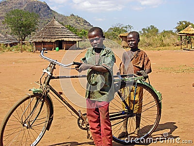 Poor African children with old bicycle remote village Africa Editorial Stock Photo