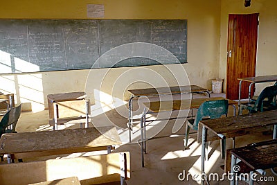 Poor african classroom with empty desks Stock Photo