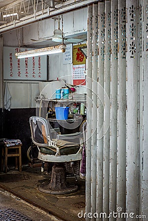 Poor Barber shop in a garage in Hong Kong Editorial Stock Photo