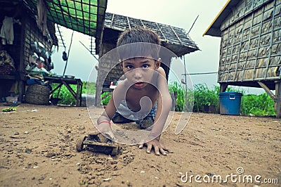 Poor cambodian kid playing Editorial Stock Photo