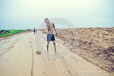 Poor cambodian kid playing Editorial Stock Photo