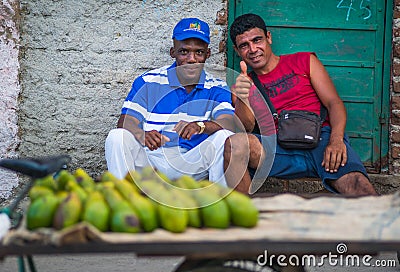 Poor Cuban business man capture portrait in traditional colorful colonial alley with old life style, in old town, Cuba, America. Editorial Stock Photo