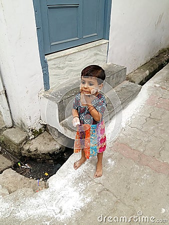 Small Girl Applying White Wash in her Face Editorial Stock Photo