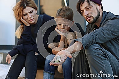 Poor homeless family begging Stock Photo