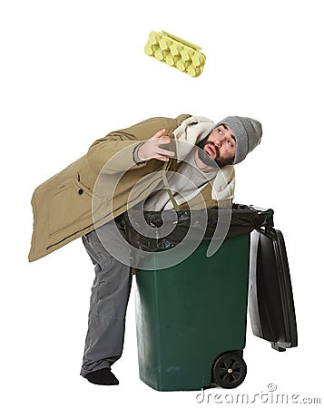 Poor homeless man digging in trash bin on white Stock Photo