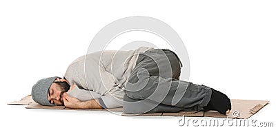 Poor homeless man lying on cardboard Stock Photo