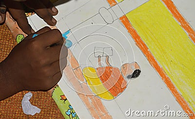 poor Indian primary school kid drawing in a Sit and draw compitition Stock Photo