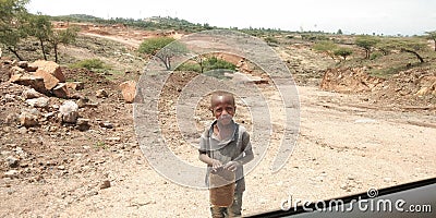 A poor Ethiopian village small boy came out from home for the search of water. Editorial Stock Photo