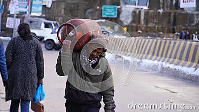 poor man with gas cylinder and going home image Editorial Stock Photo