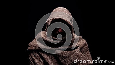 Poor man in rough robe looking down with humility, early christian prophet Stock Photo