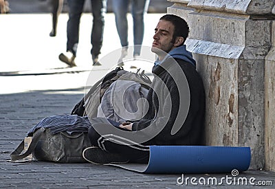 Poor men asks for money in a commercial street in Barcelona Editorial Stock Photo