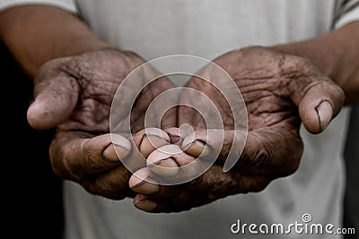 The poor old man`s hands beg you for help. The concept of hunger or poverty. Stock Photo