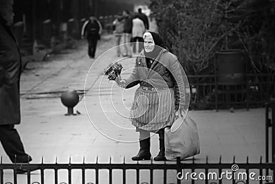 Poor old woman selling dried flowers on the street Editorial Stock Photo