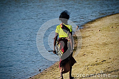 Poor old woman walking in the river bank area photograph Editorial Stock Photo