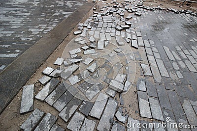 Poor quality paving stones, road blurred, road repair close up Stock Photo