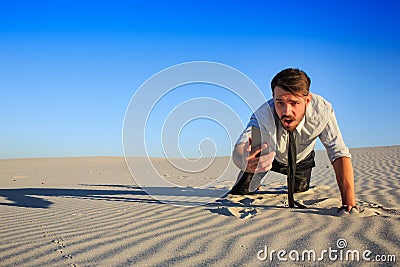 Poor signal. businessman searching for mobile phone signal in desert Stock Photo