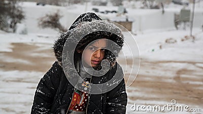 Poor Syrian Refugee Girl in a Refuge Camp at time of snow storm Editorial Stock Photo